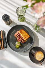 Hearty breakfast with beef steak, toast and crushed cucumbers