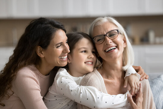 Three generational women embracing, smiling spending pleasant time together, celebrate life event, Happy Mother Day at home, close up. Family unity, love, deep connection between different generations