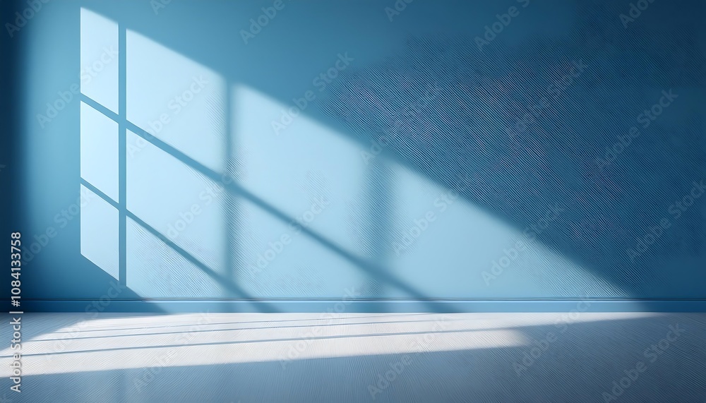 Poster shadows from a large window cross a soft blue wall as neutral light fills an empty room_1(675)