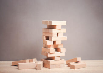Concept of business risk jenga tower on table, market risk model to study the response approach, planning for future risk diversification.