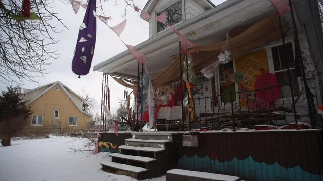  Colorfully Decorated Heidelberg Project House with Hanging Banners and Flags in Detroit Winter Snow