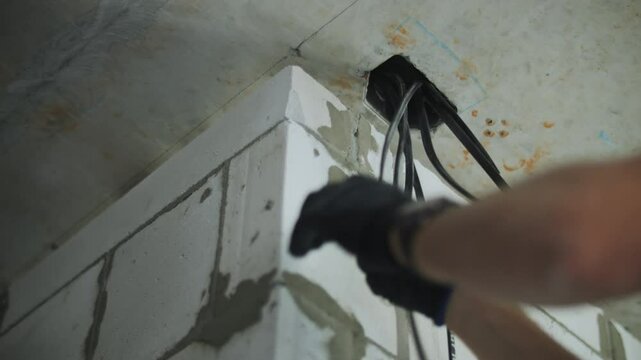 Electrician Pulling Wire In Wall