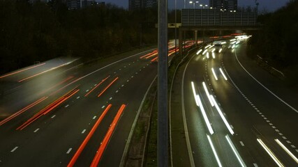 Nighttime highway traffic with blurred lights in a busy urban setting during late evening hours