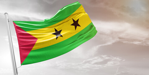 Sao Tome and Principe national flag cloth fabric waving on beautiful grey Background.