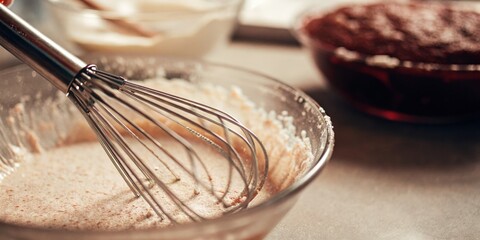 Fototapeta premium Whisking Ingredients in Bowl, Baking Preparation in Progress
