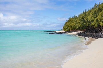Serene Beachscape with Clear Turquoise Water and Black Volcanic Rocks in Ile aux Cerfs Mauritius