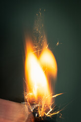 Sparks and flames produced from gas matches, burning match on black