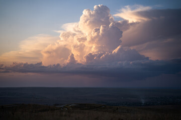 Sky at dusk or dawn with fluffy purple yellow and blue cumulus clouds, colorful evening landscape...