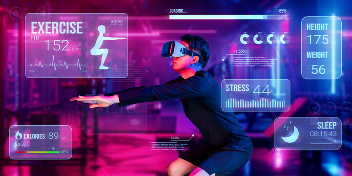 Happy asian man wearing VR glass while exercising at futuristic gym with glowing vibrant color. Male model using augmented reality technology for analysis data from holographic. Technology. Ingenuity.