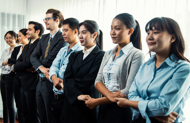 Obraz premium Modern diversity and multicultural company, business people joining hand together and standing in line, shared commitment to collaboration and cooperation concept background. Meticulous
