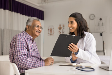Latina woman doctor general practitioner holds clipboard, showing medical checkup results, explain...