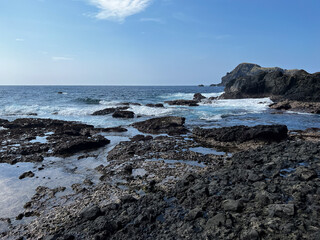 Majestic Rocky Coastline Overlooking a Calm Blue Ocean