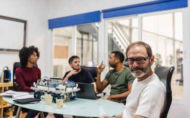 Fototapeta premium Robotics engineers developing innovative machine in modern factory