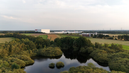 Scenic Aerial View of Lush Countryside Landscape and Industrial Buildings