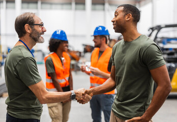 Engineers shaking hands in a modern industrial factory