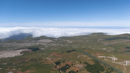 Scenic Aerial View of Rolling Green Hills and Clouds