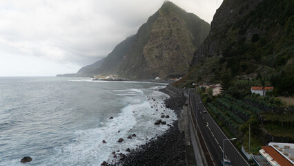 Scenic Coastal Road Along Rugged Mountain Cliffs and Ocean Waves