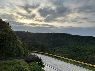Scenic Mountain Road at Sunrise with Lush Green Landscape