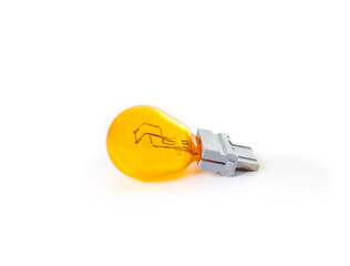 Old light bulb for front turn signal light in cars. Amber or yellow miniature lightbulb. Burned out or damaged. Also known as turn signal bulb or indicator bulb. Selective focus. White background.