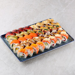 Japanese sushi rolls, sushi sets on a gray background for restaurant menu and food delivery