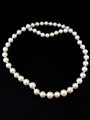 White pearl necklace with elegant black background, elegant, pearly