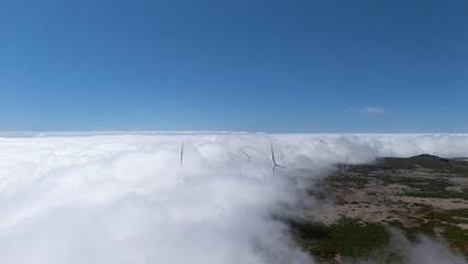 Wind Turbines Above Clouds in Scenic Landscape