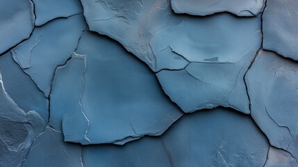 Naklejka premium Close-up texture of cracked and weathered blue rock surface with irregular shapes and rough edges