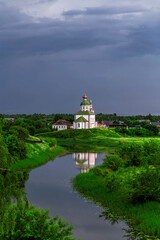 SUZDAL, RUSSIA - Beautiful landscape of Suzdal overlooking the Kamenka River and the ancient Russian Church of Elijah the Prophet (Ilyinsky Church)At sunset
