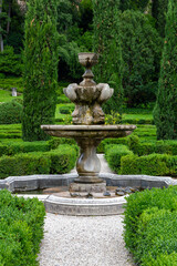 Obraz premium a stone fountain in the beautiful and unique city garden called Giardino Giusti in Verona, Italy. 