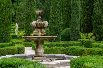 Obraz premium a stone fountain in the beautiful and unique city garden called Giardino Giusti in Verona, Italy. 