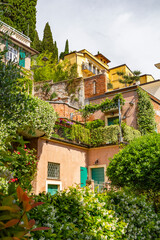 a beautiful vivid small alley with colorful tiny Italian villas on a steep hill in verona, Italy 