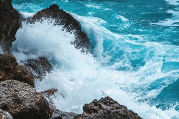 Waves crashing against rocky shore, showcasing the beauty of nature and ocean dynamics.