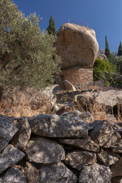 Unique anti pirate stone house with giat rock boulder on the Greek Island of Ikaria