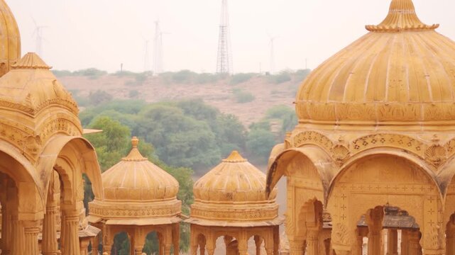 Bada Bagh cenotaphs made of yellow sandstone in Indian Thar desert at Jaisalmer, Rajasthan, India. Tourism in Jaisalmer, golden city. Tombs of Hindu royal kings. Cultural heritage of India.