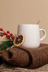 Cozy winter lifestyle concept. Cup of hot drink with warm knitted clothes.	

