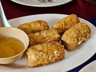 Fried spring rolls local restaurant food photography indoor setting close-up view culinary delights