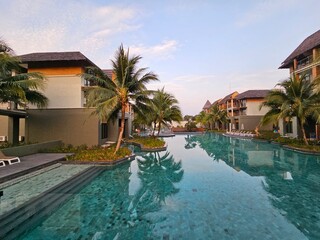Obraz premium Relaxing swim at a luxury resort pool tropical destination photography calm setting aesthetic view vacation vibes