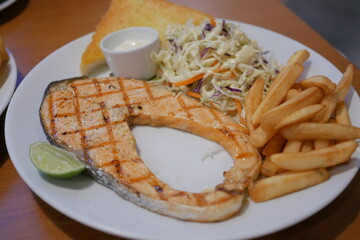Grilled salmon dish coastal restaurant food plating casual dining close-up view culinary delight