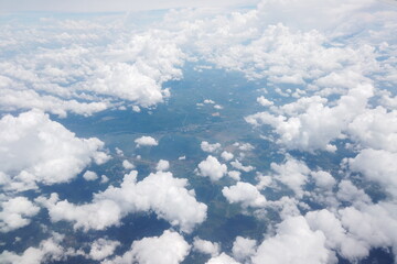 Aerial view of lush green landscapes and fluffy clouds above the earth nature photography serene atmosphere drone perspective nature's beauty