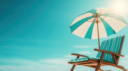 An inviting wooden chair and azure-striped beach umbrella dominate this coastal setting, offering an idyllic oasis against the vast, sunny blue sky and sea.