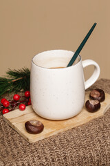 Cozy winter lifestyle concept. Cup of hot drink with warm knitted clothes.	
