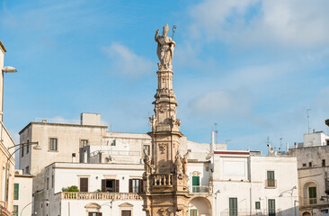 View of the Column of Saint Oronzo located in Liberty square in Ostuni, province of Brindisi, Puglia, Italy