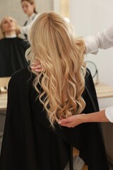 Fototapeta premium Hair cutting. Professional hairdresser working with client in salon, closeup