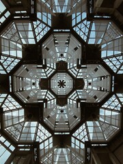 Modern architecture of National Gallery of Canada glass ceiling with hexagonal symmetry, capturing light, sky reflections, and intricate patterns in an artistic display