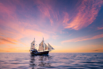 Seascape view with sailing boat and colorful cloudy sunset, Tenerife