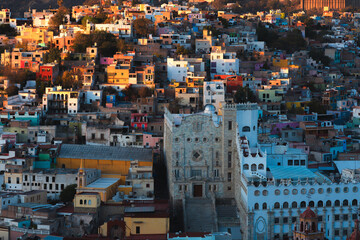 The University of Guanajuato, Mexico stands prominently amidst vibrant hillside homes in a scenic...