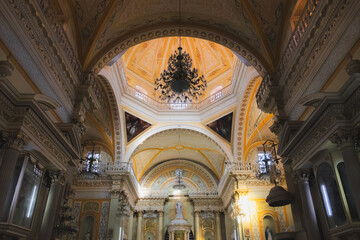 The ornate vaulted ceiling and baroque interior of the Guanajuato Basilica showcase its grandeur and sacred charm in Guanajuato, Mexico.