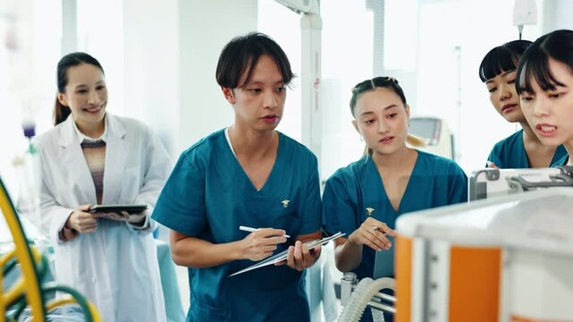Healthcare, doctor and students with simulation for education, medical practical and discussion. People, team and notes for learning with icu procedure, training or physician for observation in Japan