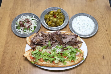 The most common variety of kebab is marinated lamb or beef cooked on a skewer. Vegetables are sometimes cooked along with them, wherein typical vegetables include eggplant, tomato, bell pepper, onions