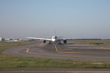 a plane on a runway at the airport